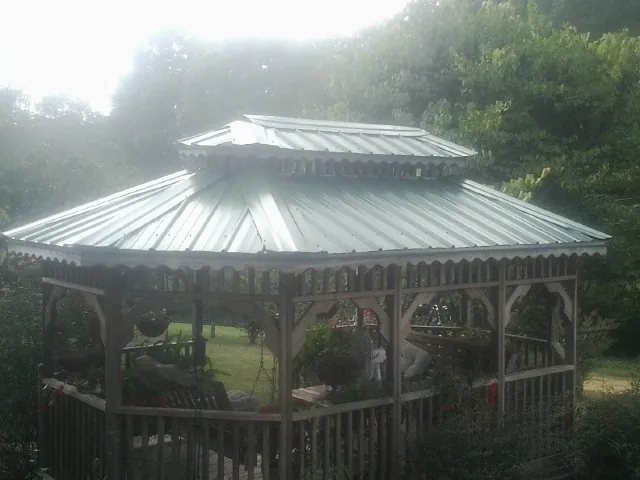 Two tier green metal roof on a garden gazebo in Commodore